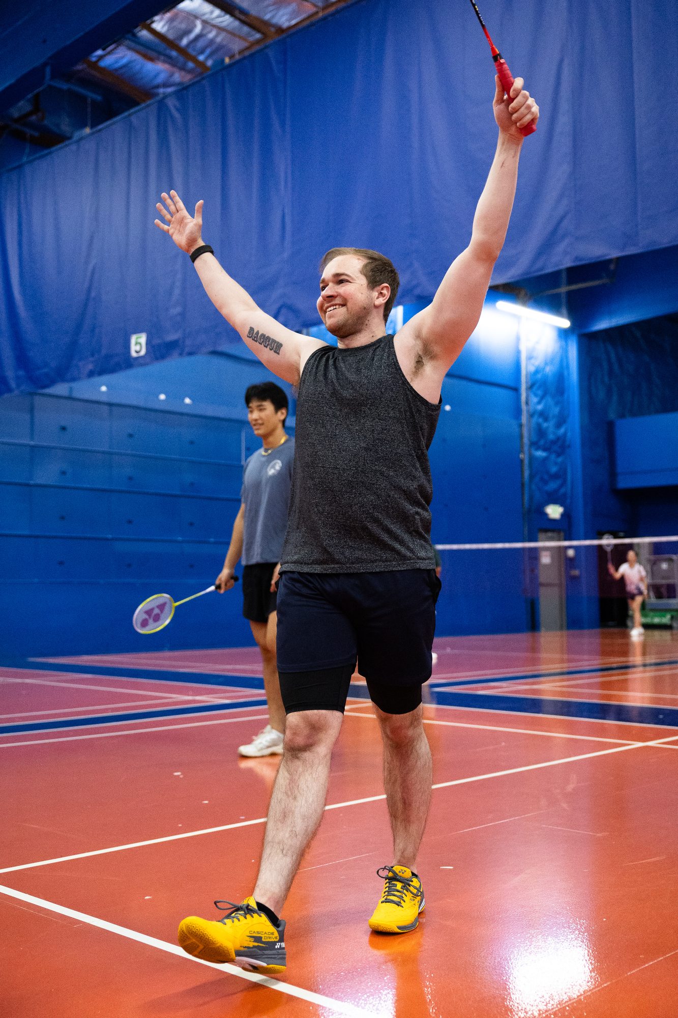 Beginner player celebrating at Badminton 101